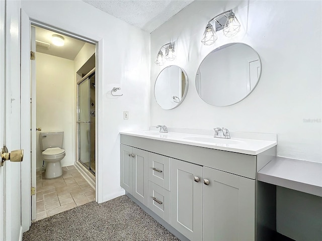 bathroom with toilet, a shower with door, a textured ceiling, and vanity