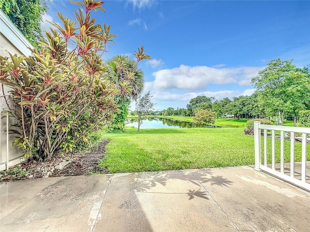 view of yard with a patio area and a water view