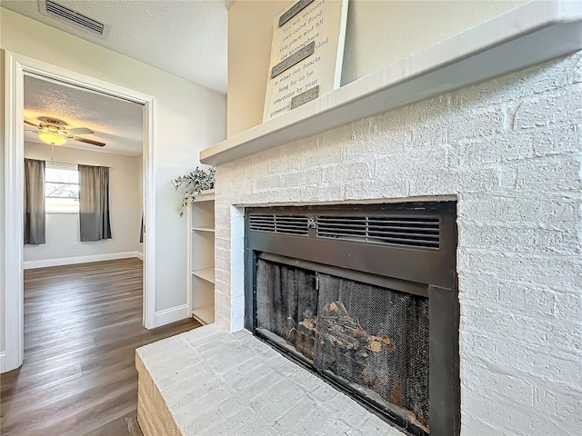 details with ceiling fan, hardwood / wood-style floors, and a textured ceiling