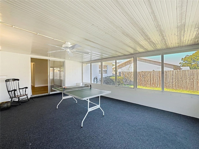 sunroom / solarium with wooden ceiling and ceiling fan