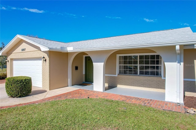 view of front of home featuring a garage and a front lawn