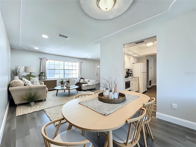 dining space featuring recessed lighting, visible vents, dark wood finished floors, and baseboards