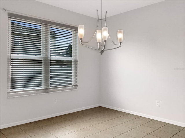 unfurnished dining area with tile patterned floors and a chandelier