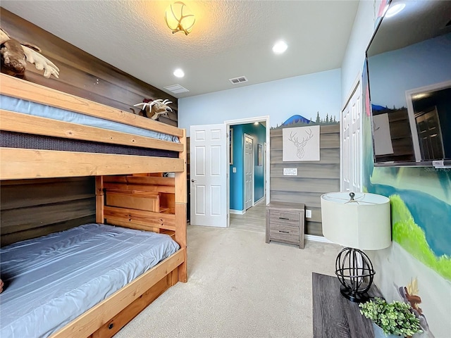 bedroom with a closet, carpet flooring, and a textured ceiling