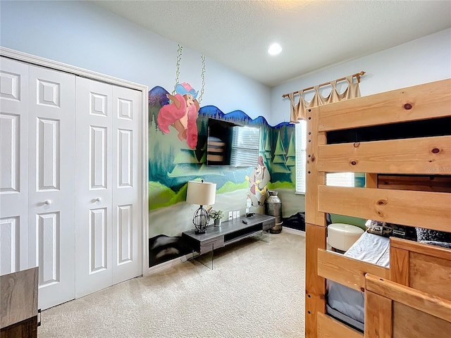 carpeted bedroom with a closet and a textured ceiling