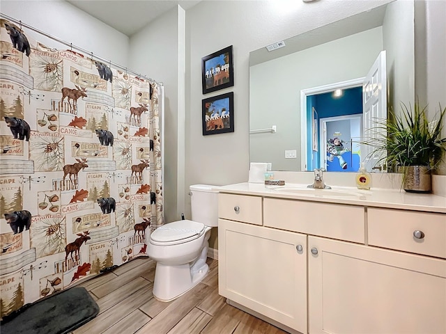 bathroom with toilet and vanity