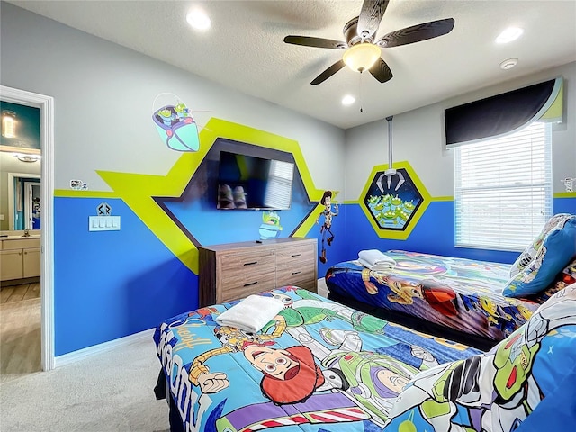 carpeted bedroom featuring sink, connected bathroom, and ceiling fan