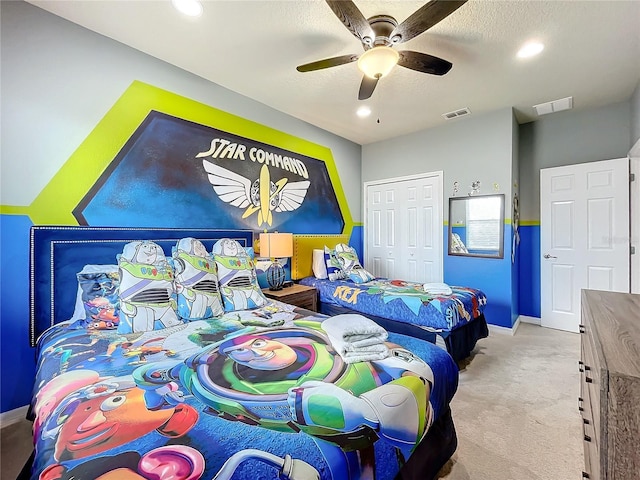 carpeted bedroom featuring a closet and ceiling fan