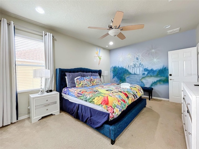 carpeted bedroom featuring ceiling fan and a textured ceiling