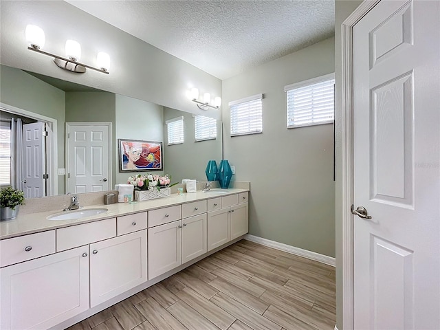 bathroom featuring vanity and a textured ceiling