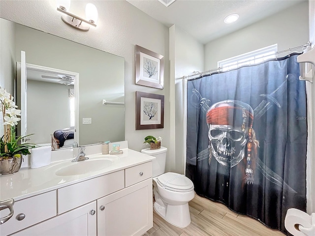 bathroom featuring toilet and vanity