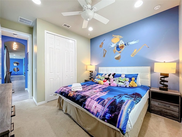 carpeted bedroom with a closet and ceiling fan