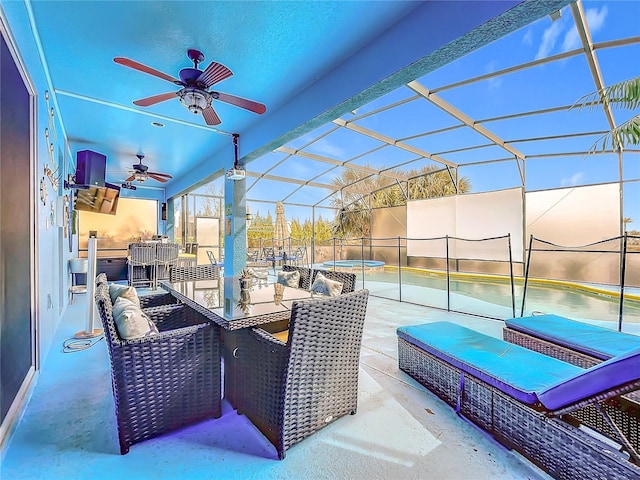 view of patio featuring ceiling fan and a lanai