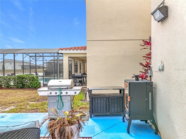 view of patio / terrace with a lanai and grilling area