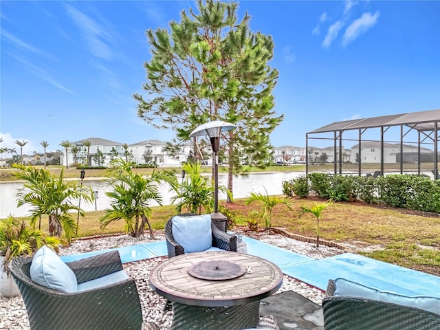 view of patio featuring a lanai and a water view