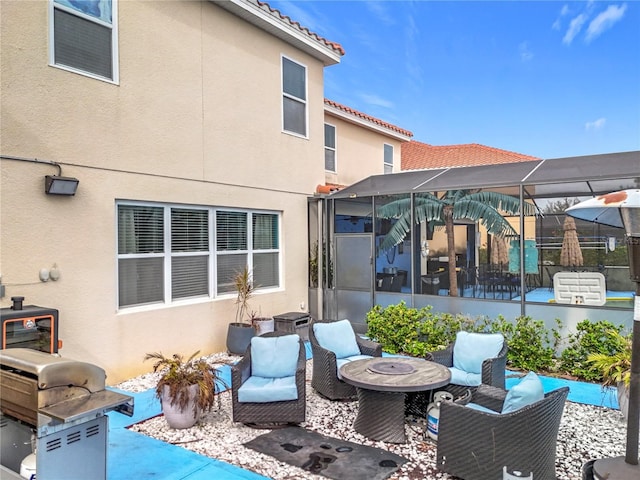 back of house with glass enclosure, a fire pit, and a patio area