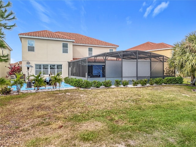 rear view of house featuring a patio area, a lanai, and a yard