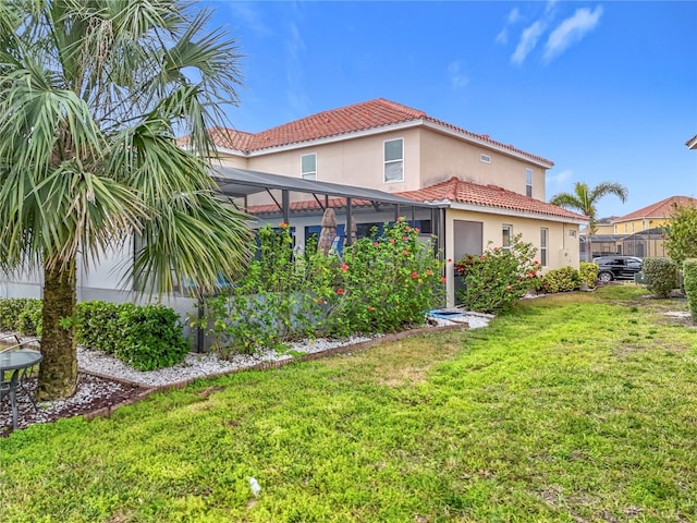 exterior space with a front yard and glass enclosure