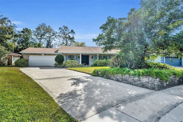 ranch-style house featuring a garage and a front lawn