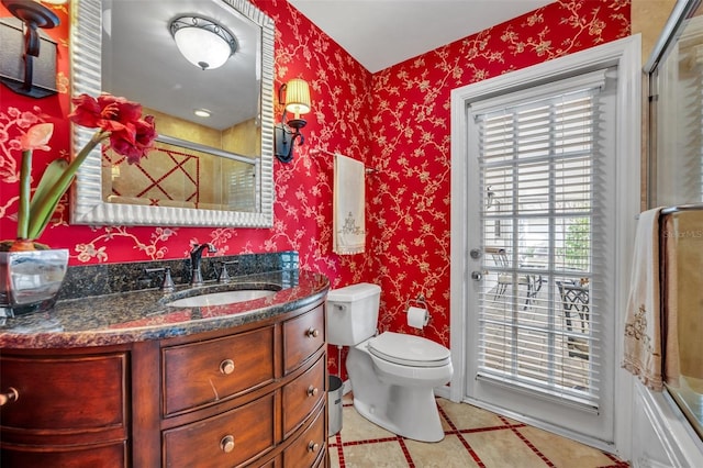 full bathroom featuring vanity, toilet, tile patterned floors, and bath / shower combo with glass door