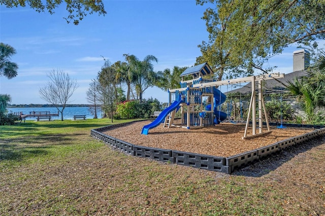 view of jungle gym with a yard and a water view