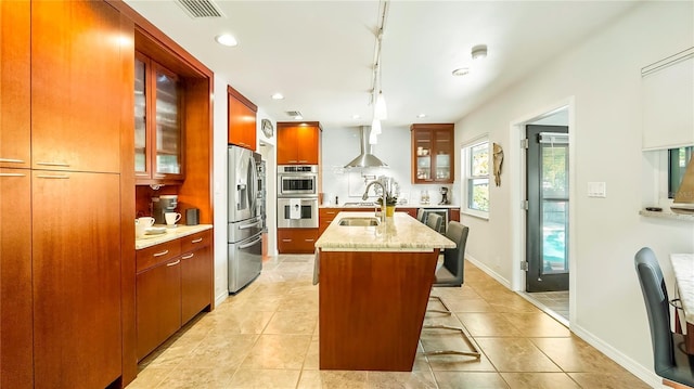 105 17th Ave NE, Saint Petersburg, FL 33704 - kitchen with a kitchen breakfast bar, visible vents, a kitchen island with sink, glass insert cabinets, and appliances with stainless steel finishes