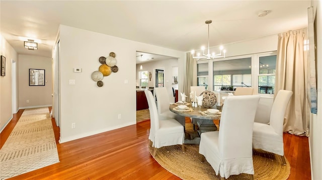 105 17th Ave NE, Saint Petersburg, FL 33704 - dining area with a chandelier, wood finished floors, a wealth of natural light, and baseboards