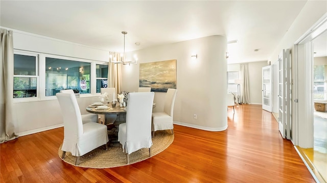 105 17th Ave NE, Saint Petersburg, FL 33704 - dining area with a healthy amount of sunlight, wood finished floors, and a chandelier