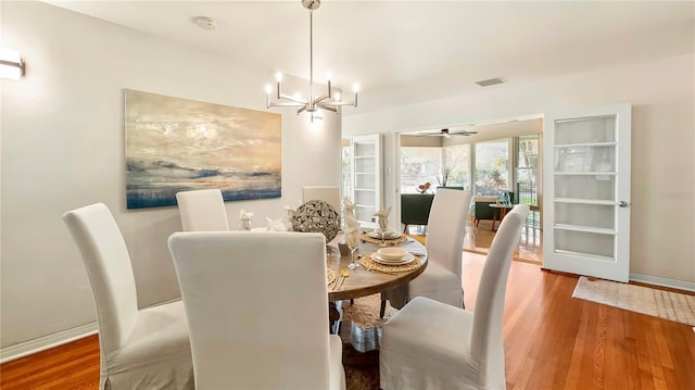 105 17th Ave NE, Saint Petersburg, FL 33704 - dining room with an inviting chandelier, wood finished floors, visible vents, and baseboards