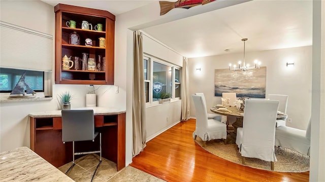 105 17th Ave NE, Saint Petersburg, FL 33704 - dining room with light wood-style flooring and a notable chandelier