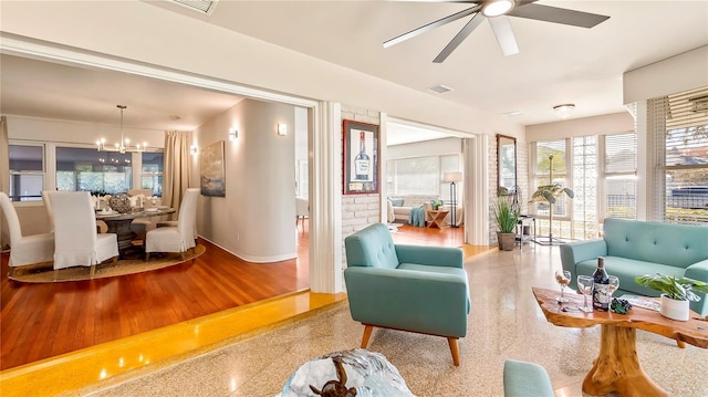 105 17th Ave NE, Saint Petersburg, FL 33704 - living area featuring visible vents, baseboards, and ceiling fan with notable chandelier