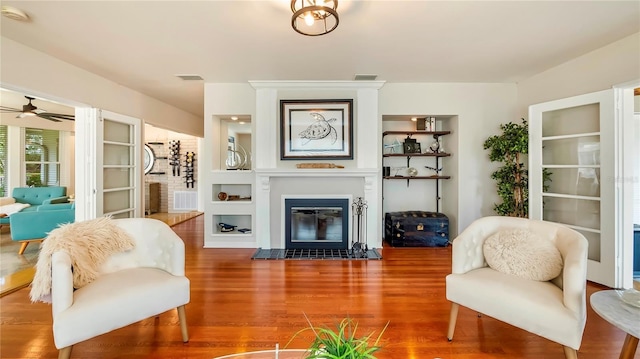 105 17th Ave NE, Saint Petersburg, FL 33704 - living room featuring visible vents, a glass covered fireplace, wood finished floors, and ceiling fan