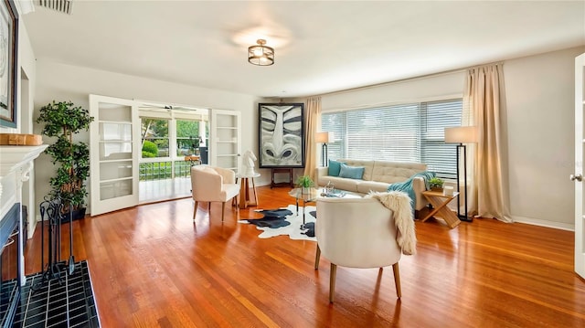 105 17th Ave NE, Saint Petersburg, FL 33704 - living area featuring a tiled fireplace, visible vents, wood finished floors, and french doors