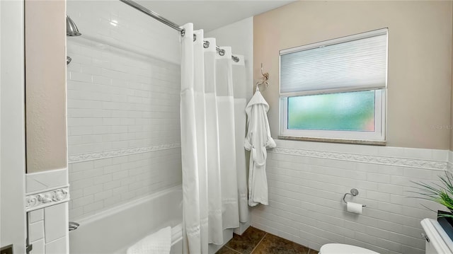 105 17th Ave NE, Saint Petersburg, FL 33704 - full bath featuring tile walls, a wainscoted wall, shower / tub combo, and toilet