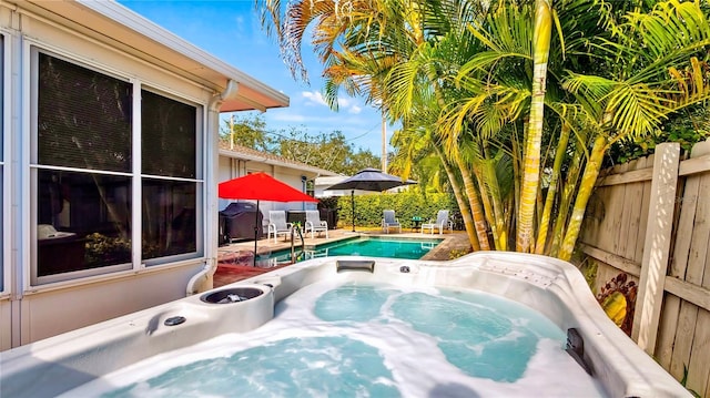 105 17th Ave NE, Saint Petersburg, FL 33704 - deck with a fenced in pool, a patio, a fenced backyard, and an outdoor hot tub