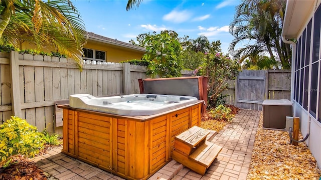 105 17th Ave NE, Saint Petersburg, FL 33704 - view of patio featuring a hot tub and fence