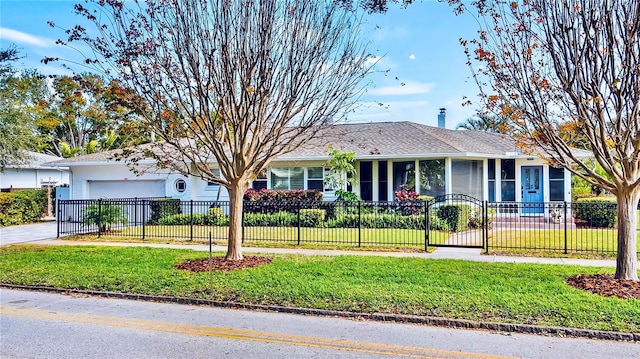 105 17th Ave NE, Saint Petersburg, FL 33704 - ranch-style home with a fenced front yard, a front lawn, driveway, and an attached garage