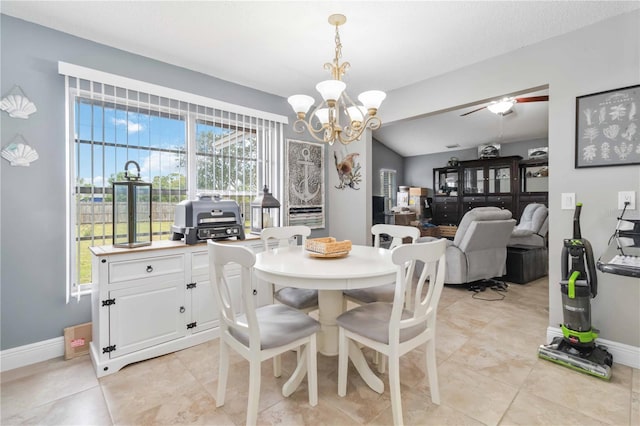 dining area featuring an inviting chandelier and vaulted ceiling