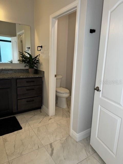 bathroom featuring vanity and toilet