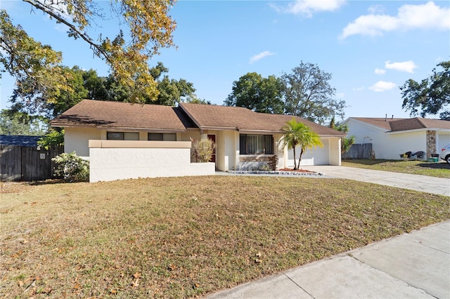 single story home featuring a garage and a front lawn