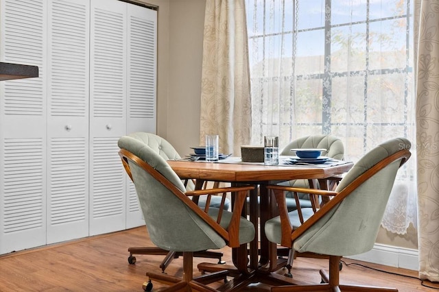 dining space with wood-type flooring