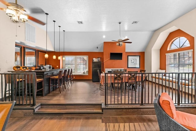 dining space with lofted ceiling, dark hardwood / wood-style floors, and ceiling fan