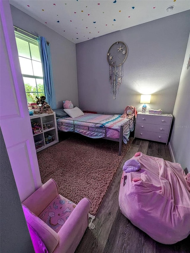 bedroom with dark wood-type flooring