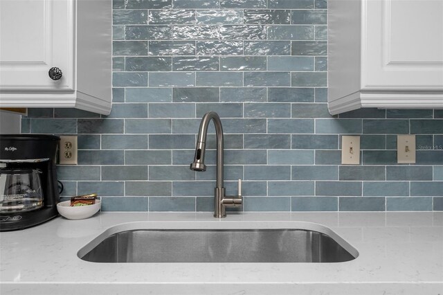 3655 Scenic Highway 98 Unit 503B, Destin, FL 32541 - kitchen view of a sink, tasteful backsplash, and white cabinets