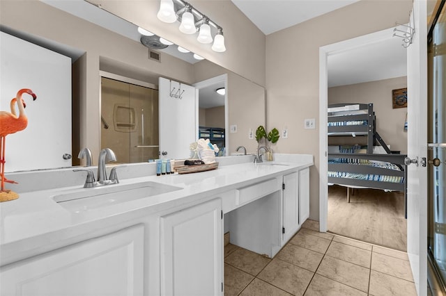 3655 Scenic Highway 98 Unit 503B, Destin, FL 32541 - bathroom with ensuite bathroom, double vanity, a shower stall, and tile patterned floors