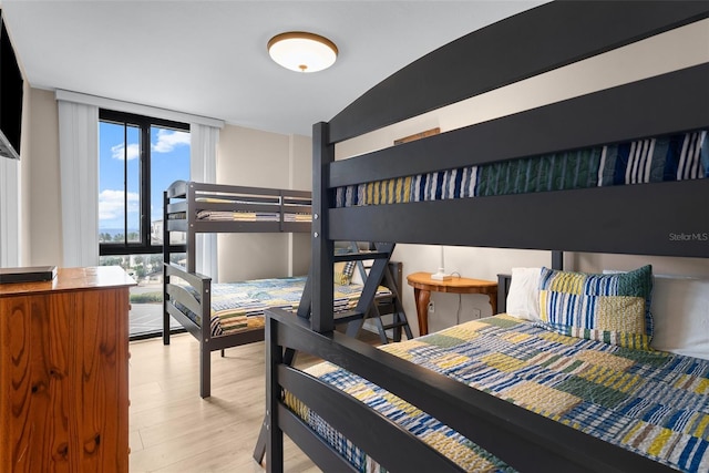 3655 Scenic Highway 98 Unit 503B, Destin, FL 32541 - bedroom featuring wood finished floors and floor to ceiling windows