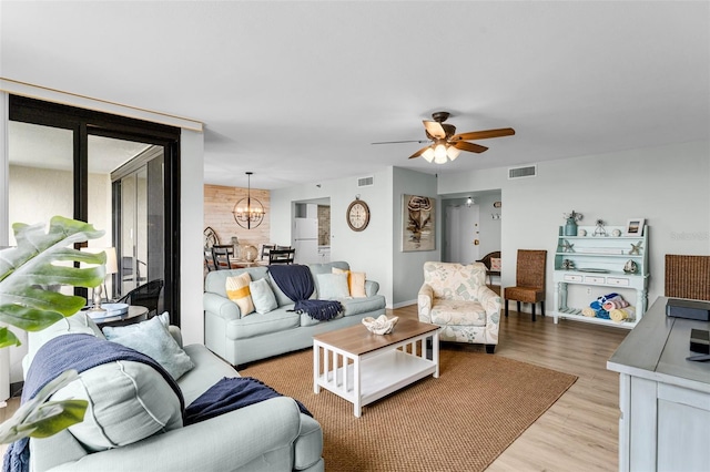 3655 Scenic Highway 98 Unit 503B, Destin, FL 32541 - living room featuring light wood finished floors, a ceiling fan, and a chandelier