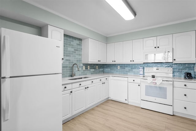3655 Scenic Highway 98 Unit 503B, Destin, FL 32541 - kitchen featuring white appliances, a sink, light countertops, decorative backsplash, and white cabinetry