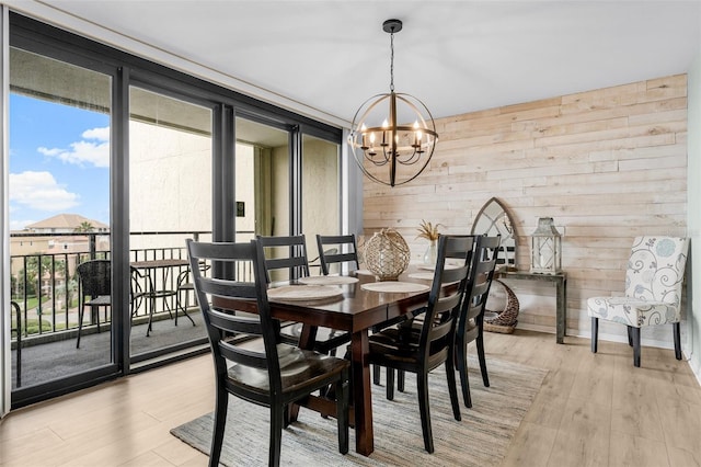 3655 Scenic Highway 98 Unit 503B, Destin, FL 32541 - dining area with a chandelier, plenty of natural light, light wood finished floors, wood walls, and expansive windows