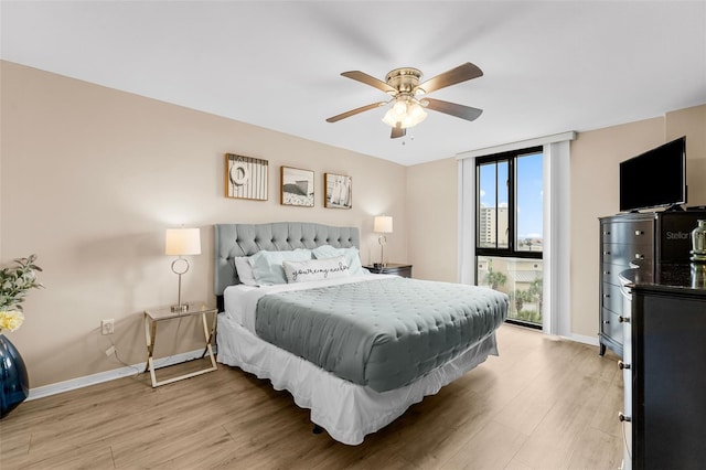 3655 Scenic Highway 98 Unit 503B, Destin, FL 32541 - bedroom featuring light wood finished floors, baseboards, a wall of windows, and ceiling fan